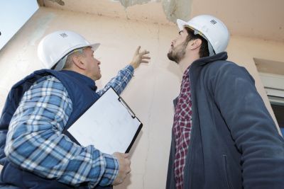 Two Contractors Accessing a Building in Joilet, IL that needs Water Damage Repairs